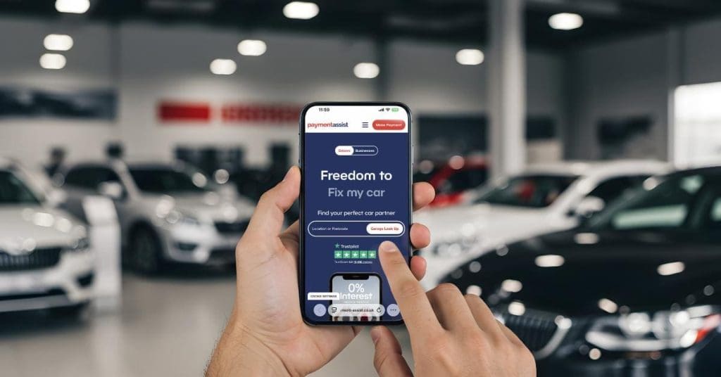 Hands in a car dealership using Payment Assist on a smartphone.