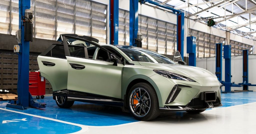 is it expensive to repair chinese cars: a chinese car in a repair bay being worked on while its doors are open